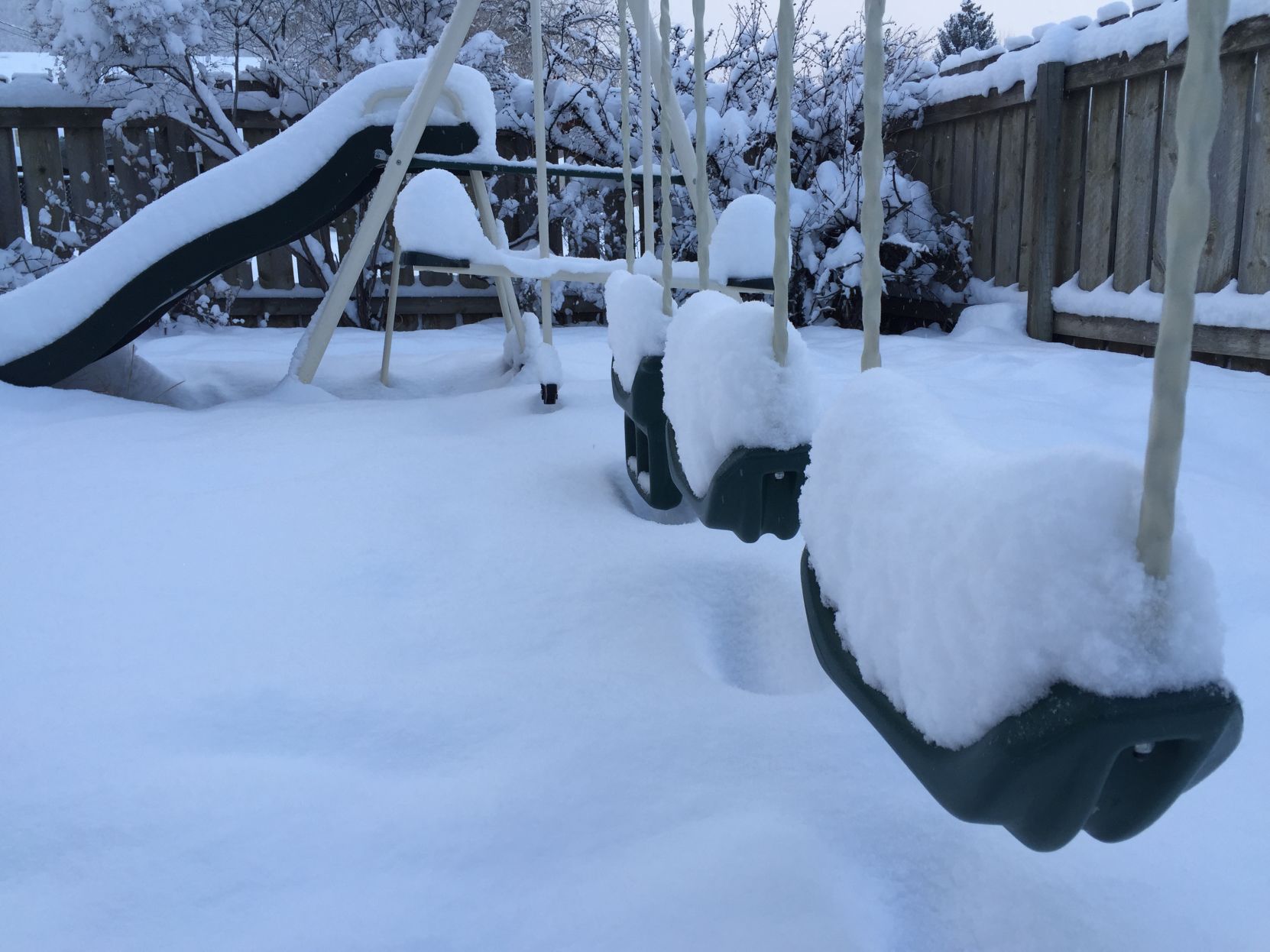 A snow-covered swingset